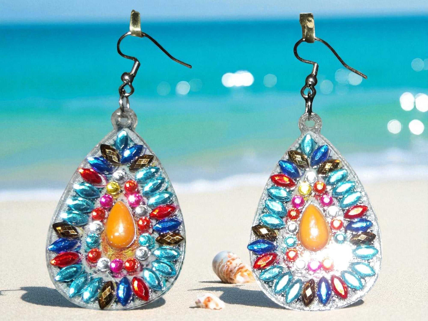 Blue & Orange Pearl handmade earrings with vibrant colorful beads and teardrop design on beach background