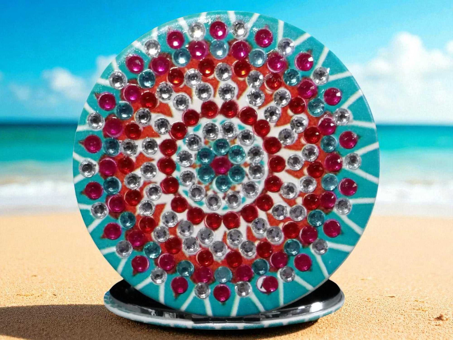 Blue and red round pocket mirror with mandala design and magnification feature on one side
