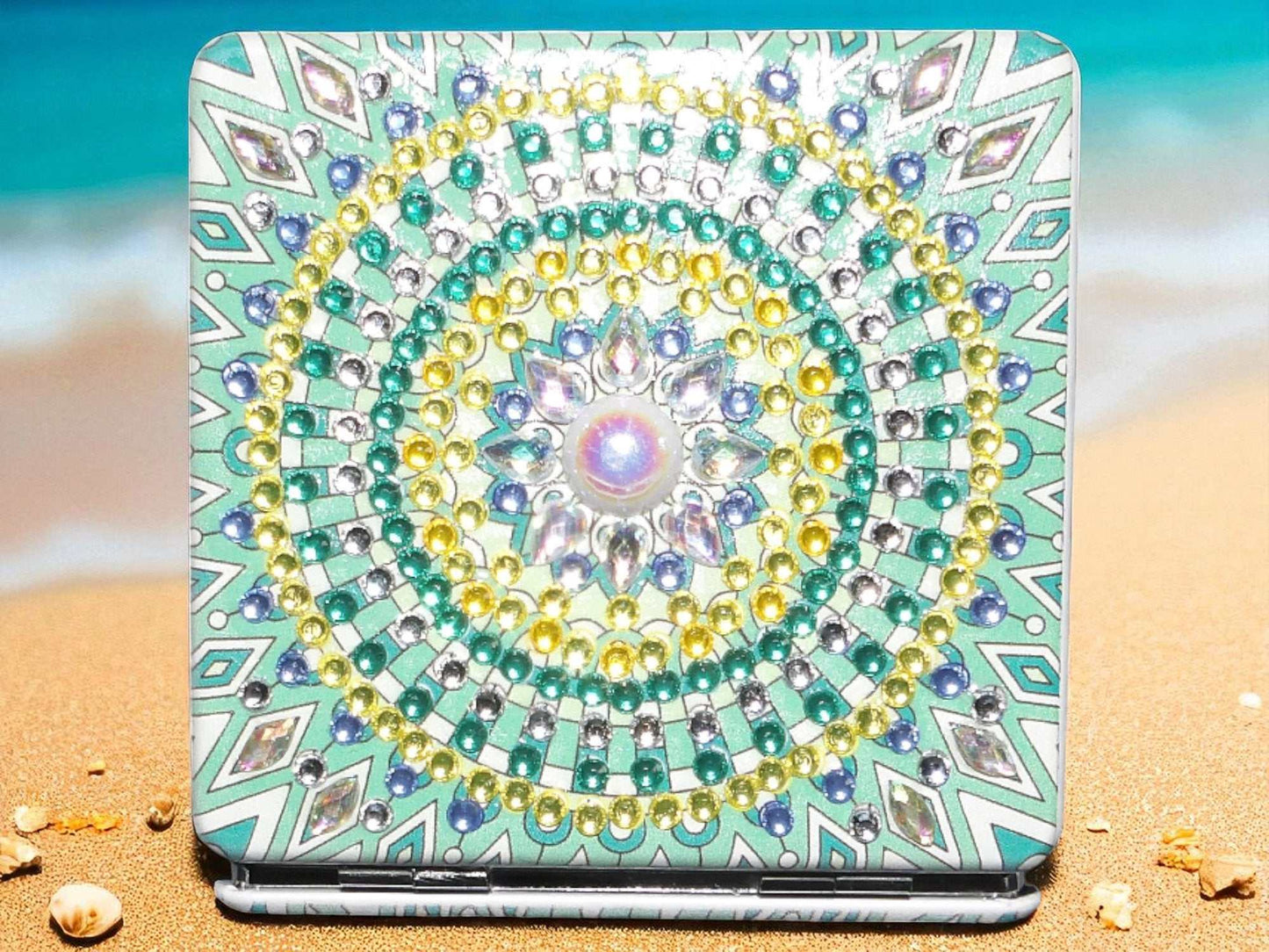 Green square pocket mirror with colorful mandala design and magnification feature