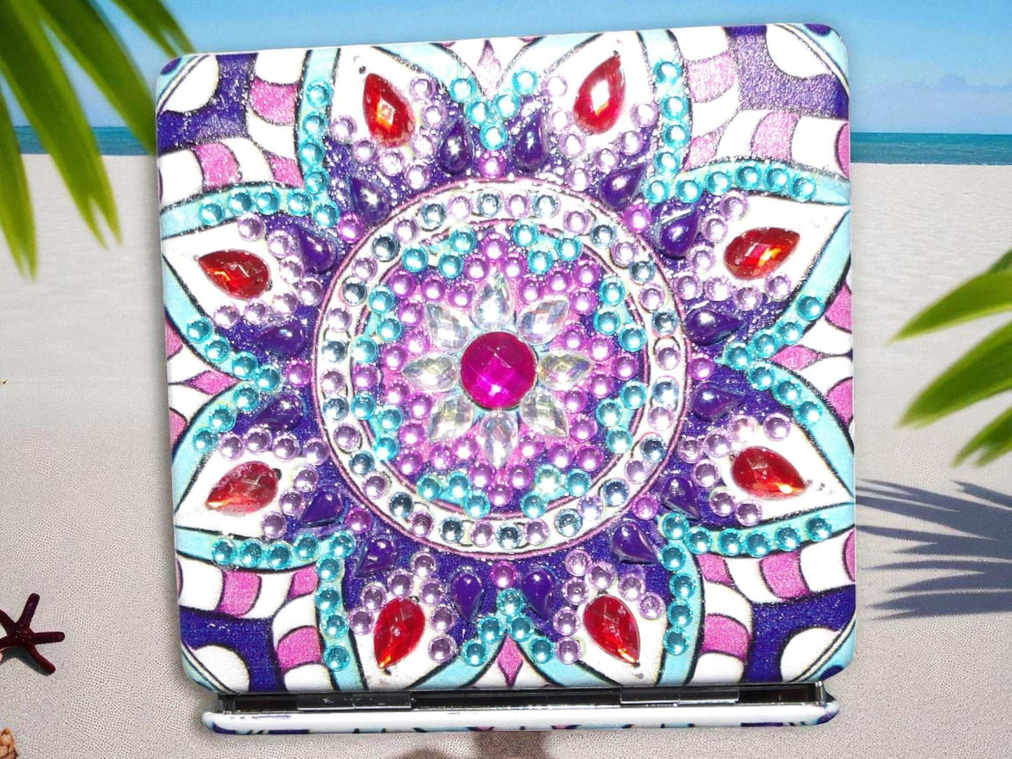 Purple square pocket mirror with colorful mandala design and magnification feature