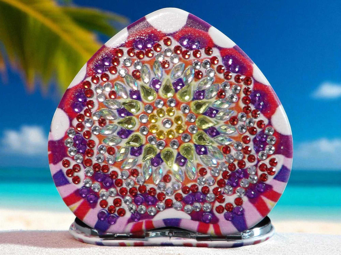 Pink and purple heart shape pocket mirror with mandala design and rhinestone embellishments.