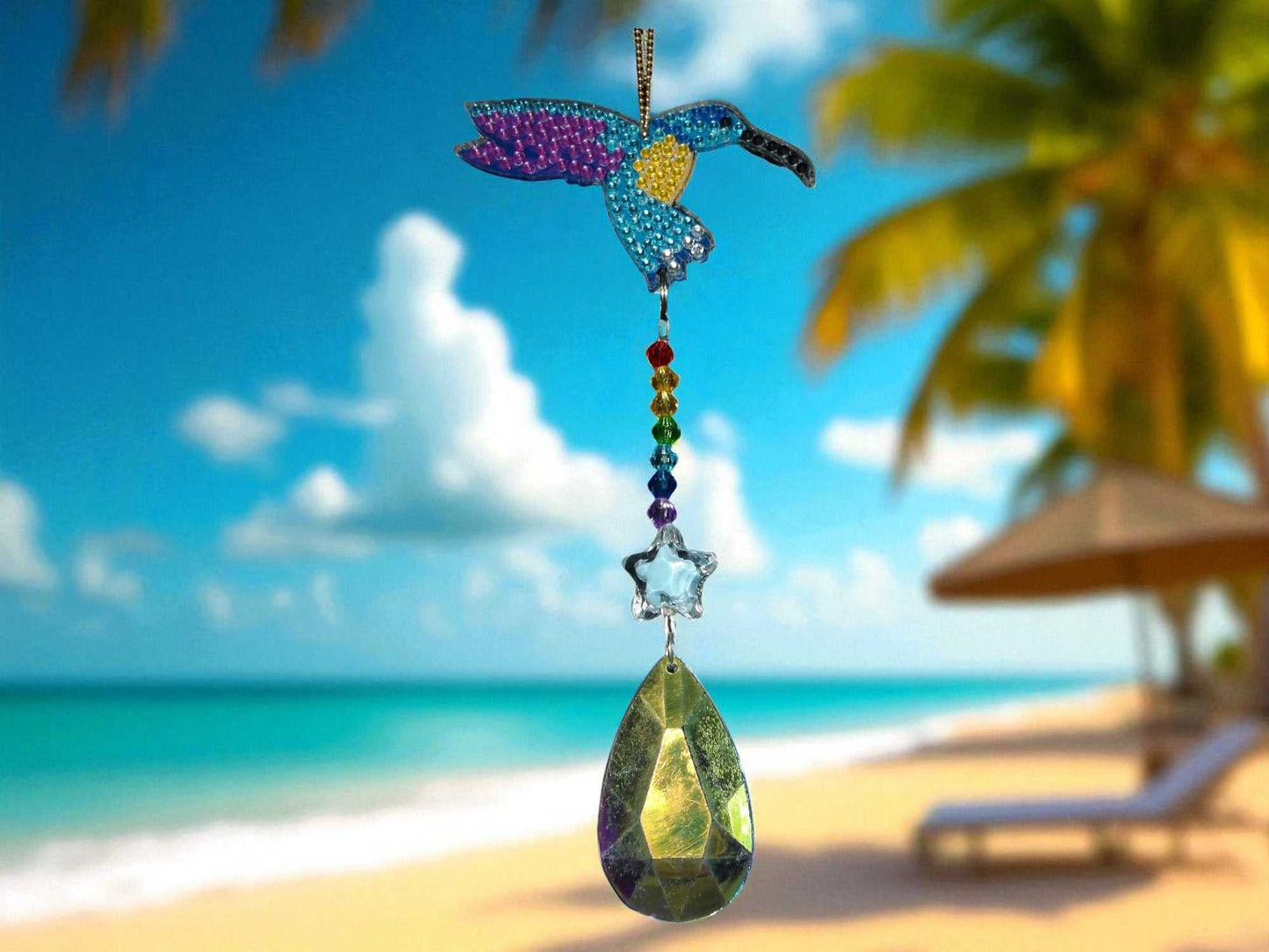 Purple Wing Hummingbird sun and wind catcher hanging with beach background