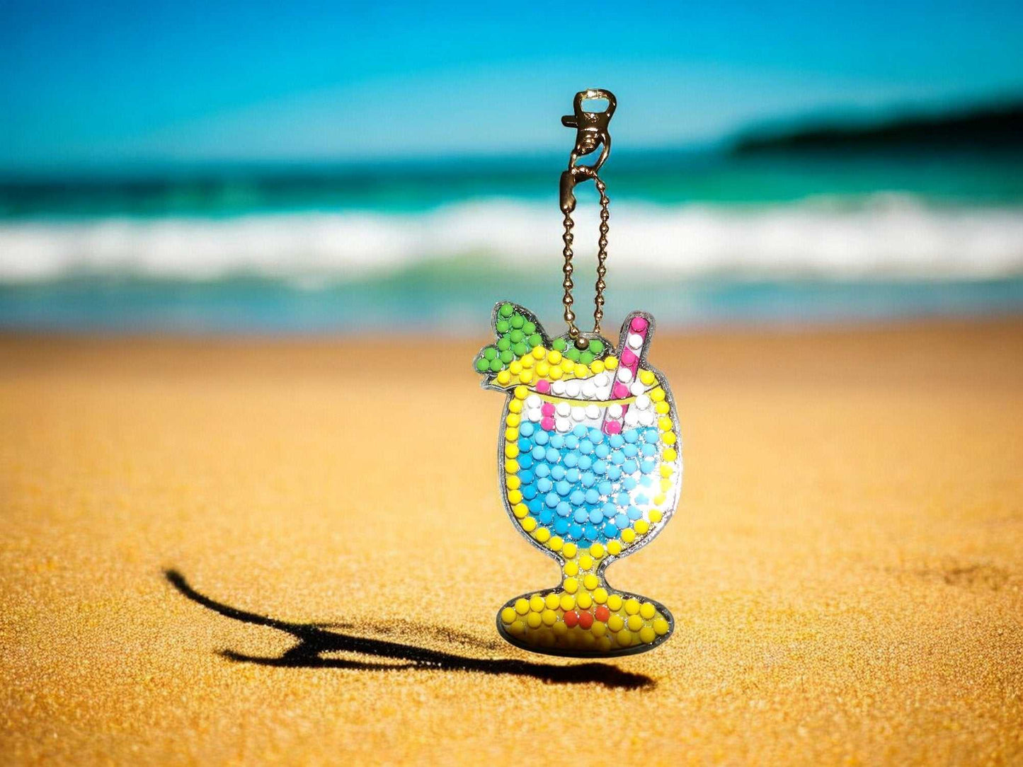 Summer Beach Drink keychain with colorful cocktail design on sandy beach background