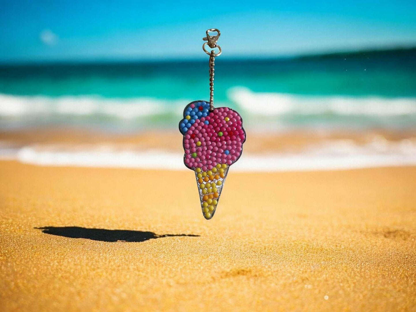Colorful ice cream cone keychain hanging with beach and ocean background