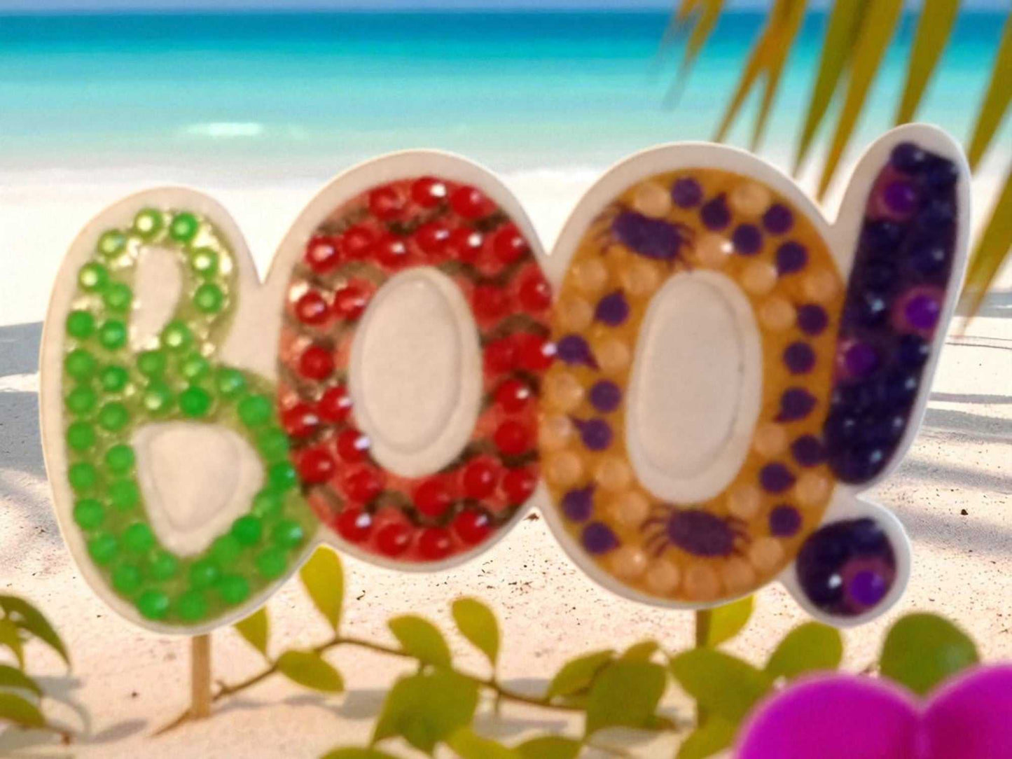 Glow In The Dark BOO Magnet with colorful beads on beach background