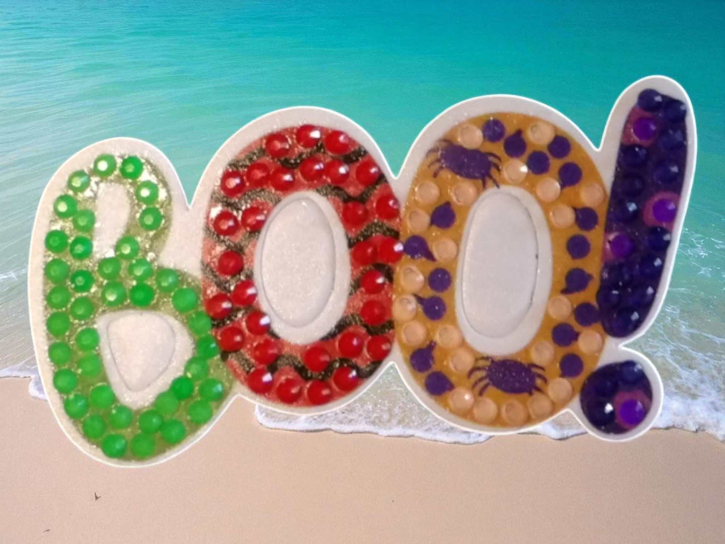 Glow In The Dark BOO Magnet with colorful beads and spider design on beach background