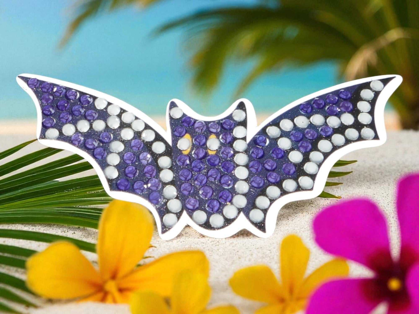 Glow in the dark flying bat magnet with purple and white rhinestones