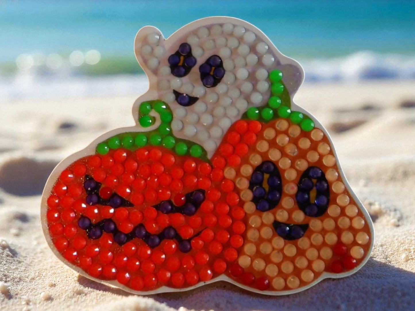 Glow in the dark Halloween family magnet featuring ghost and pumpkins design