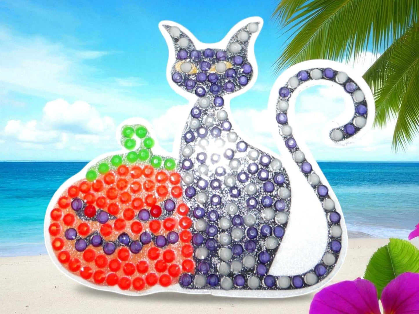 Glow in the dark black cat magnet with pumpkin design on beach background