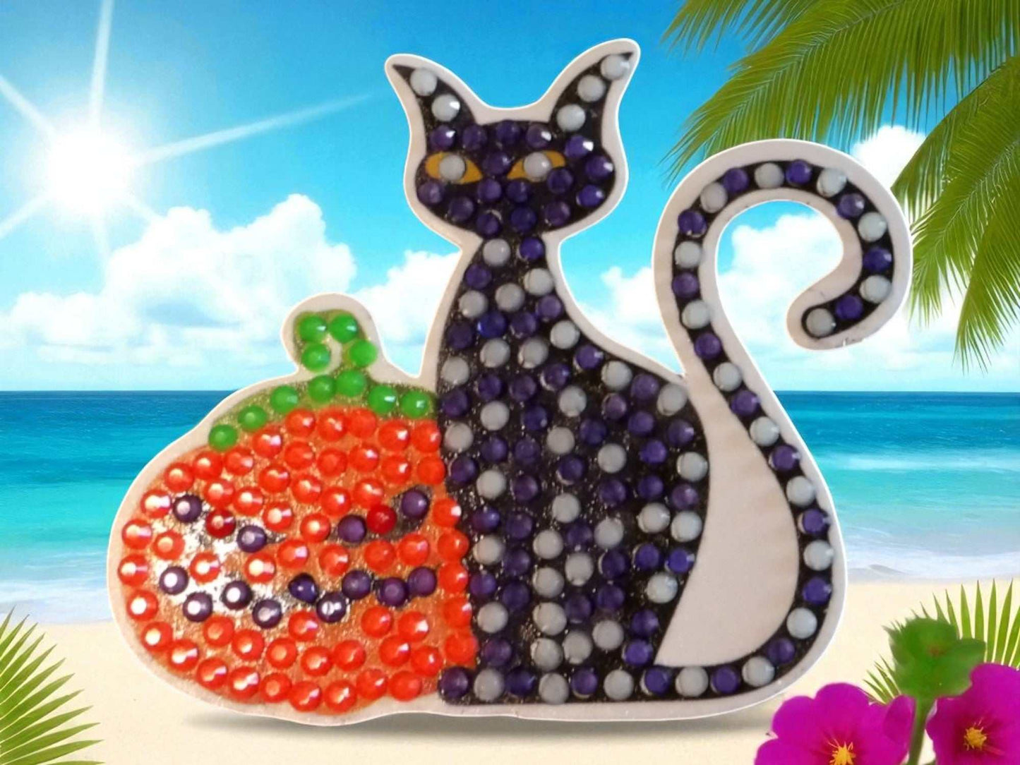 Glow in the dark black cat magnet with pumpkin design on beach background