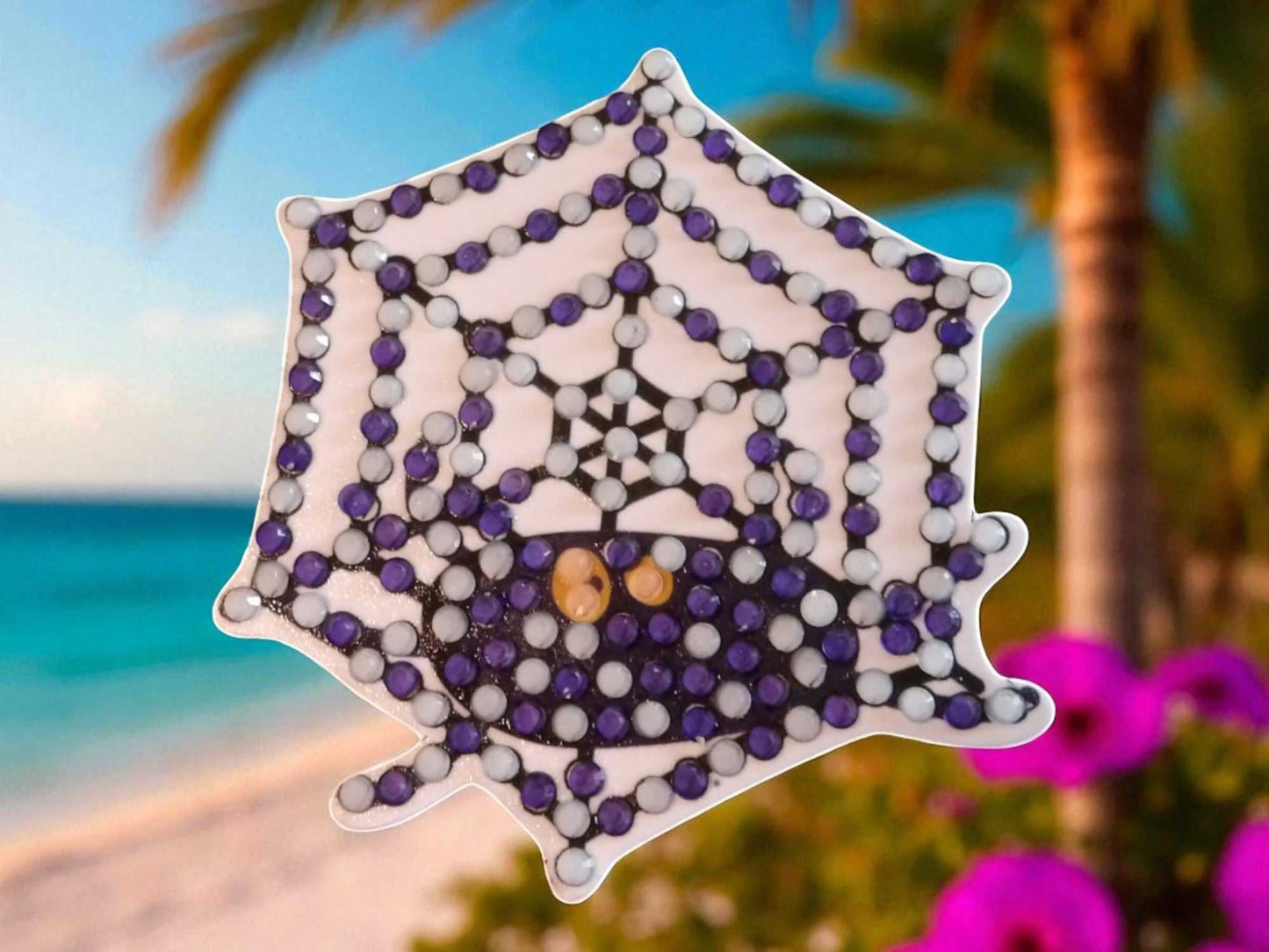 Glow in the dark spider on spider web magnet with purple and black design