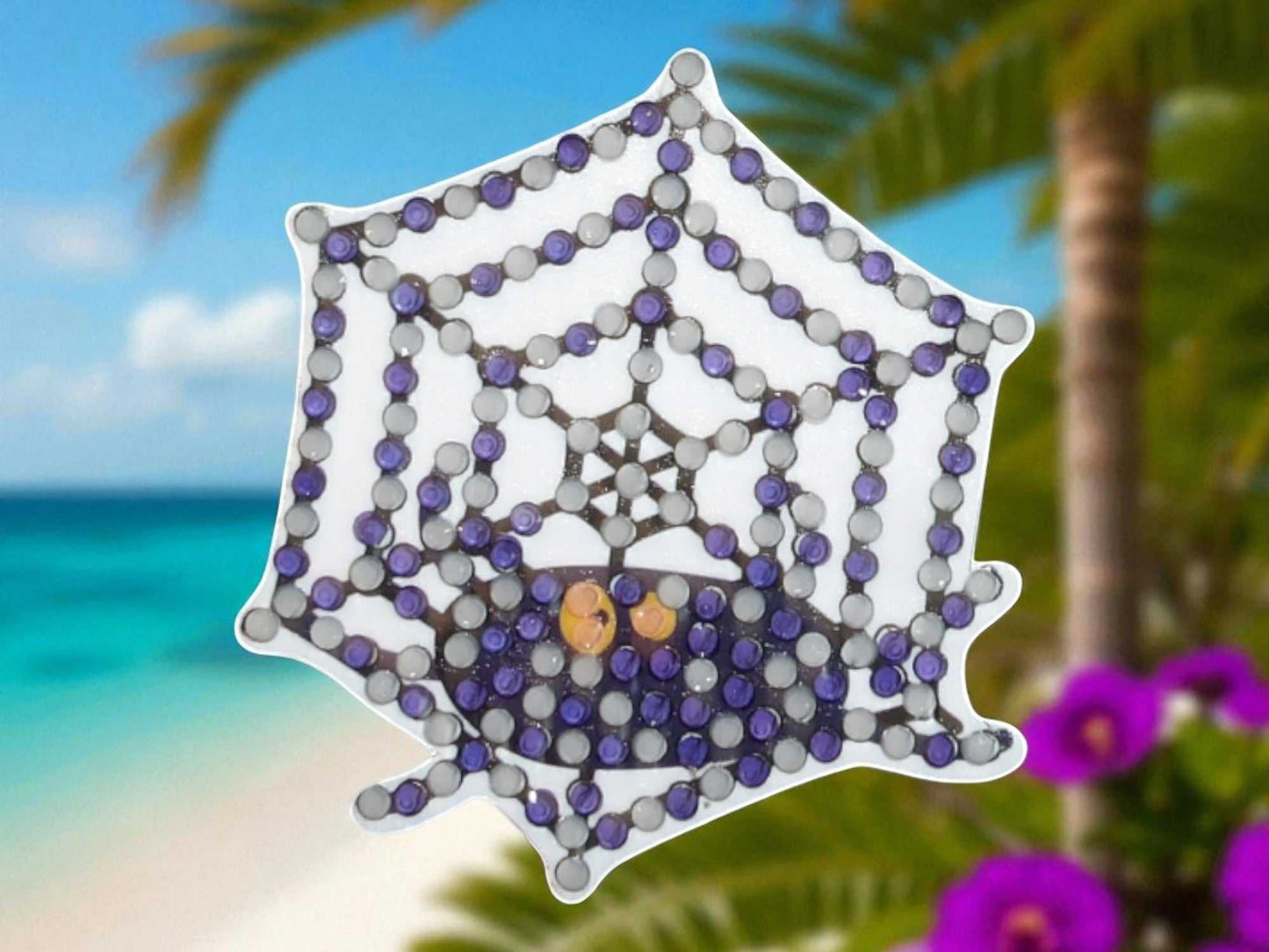 Glow in the dark spider on spider web decorative magnet with purple and black beads