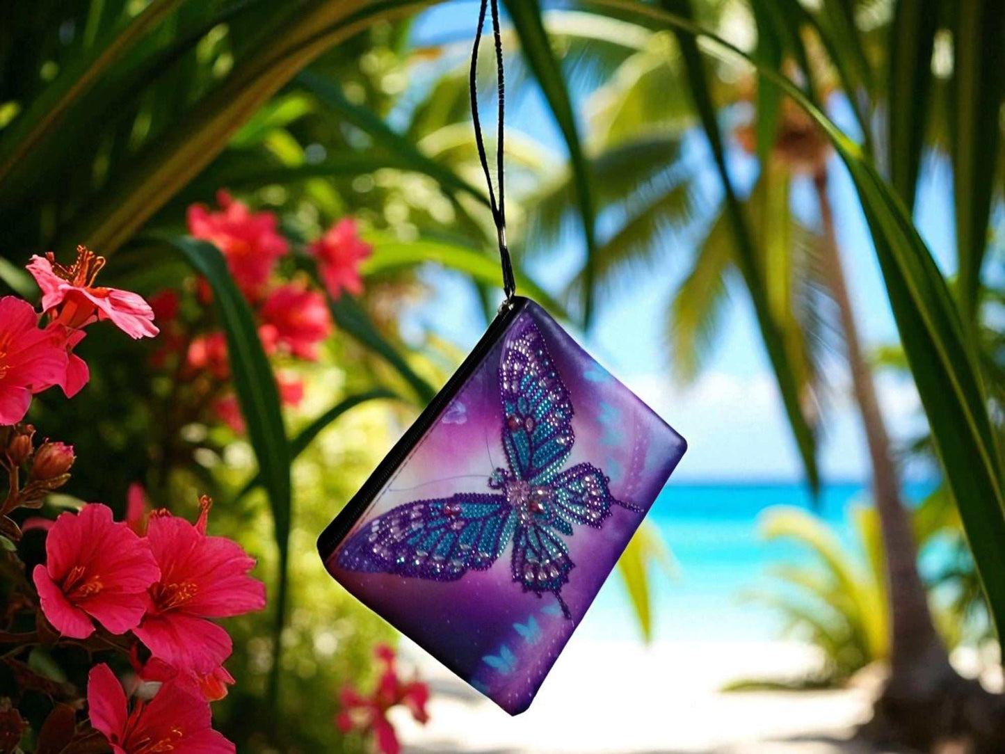 Large purple blue butterfly hand clutch with decorative butterfly motif hanging outdoors near tropical flowers and palm trees