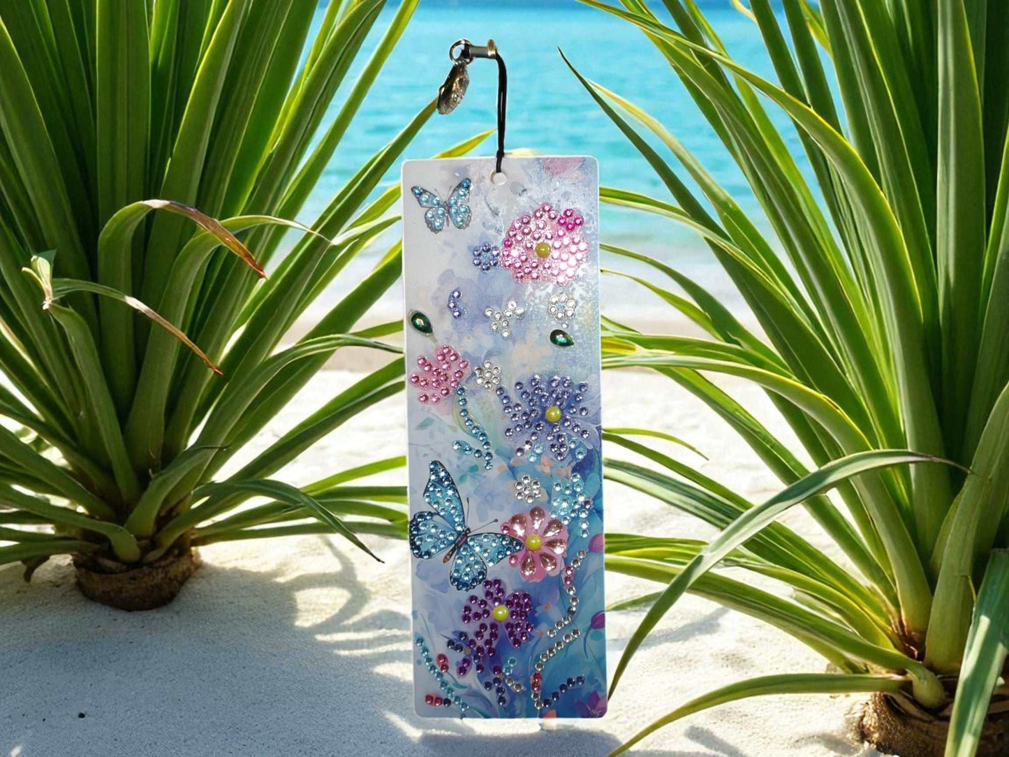 Beautiful colorful bookmark with butterflies and flowers design outdoors