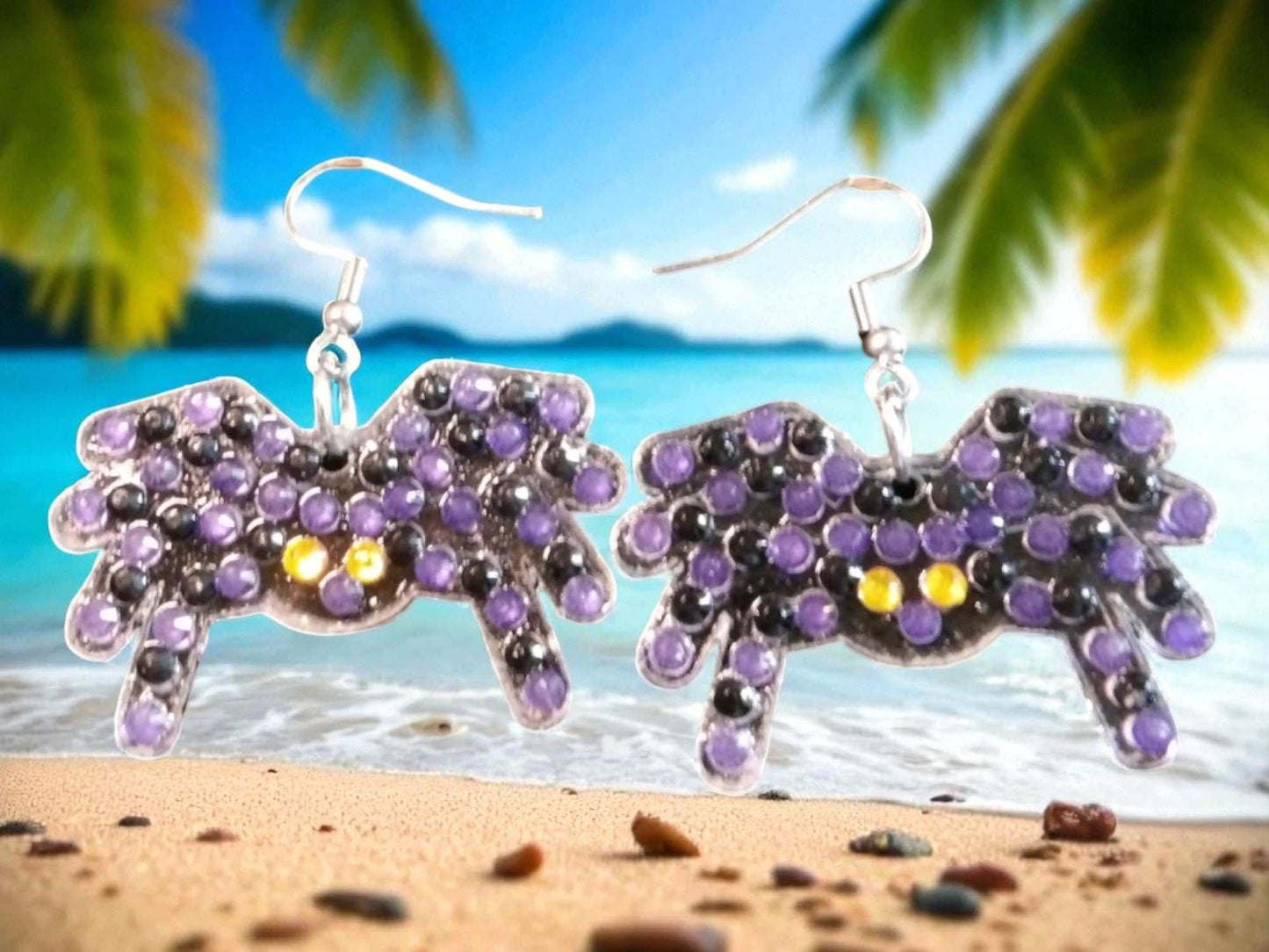 Glow in the dark spider shaped handmade earrings with purple and yellow accents