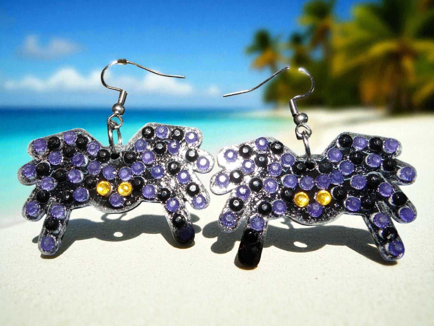 Glow in the dark spider shaped handmade earrings with purple and yellow accents