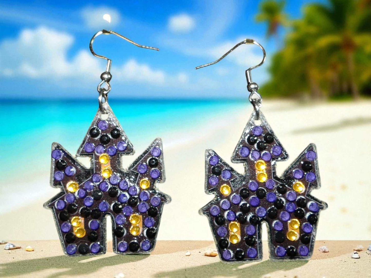 Glow in the dark spooky house earrings with purple and yellow accents