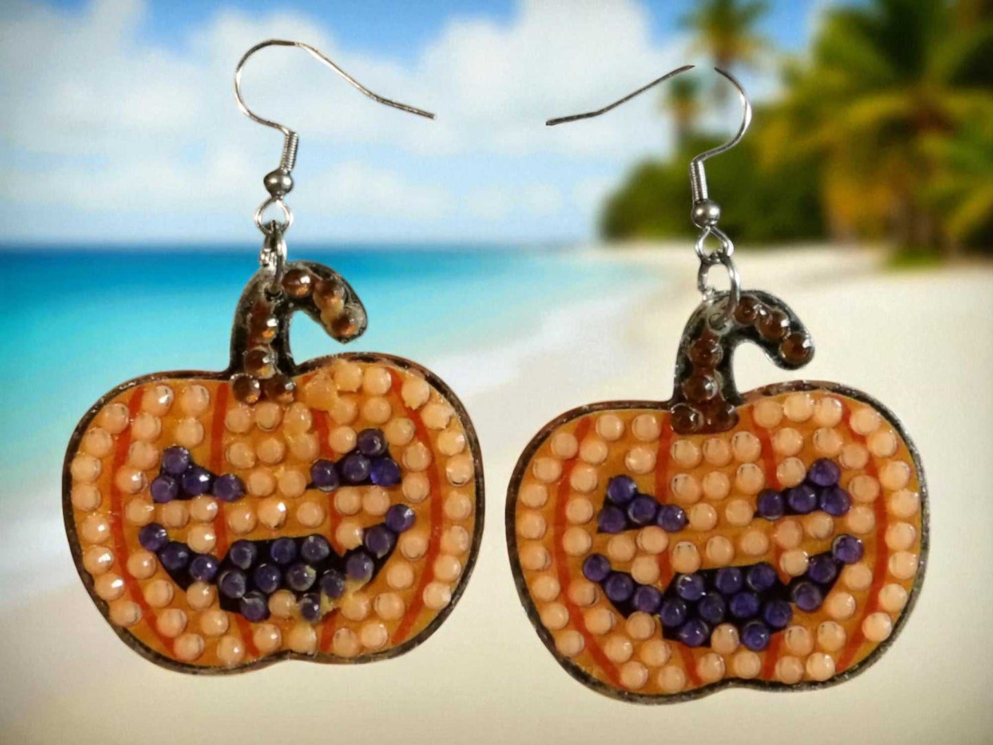 Glow in the dark pumpkin-shaped handmade Halloween earrings with smiling faces