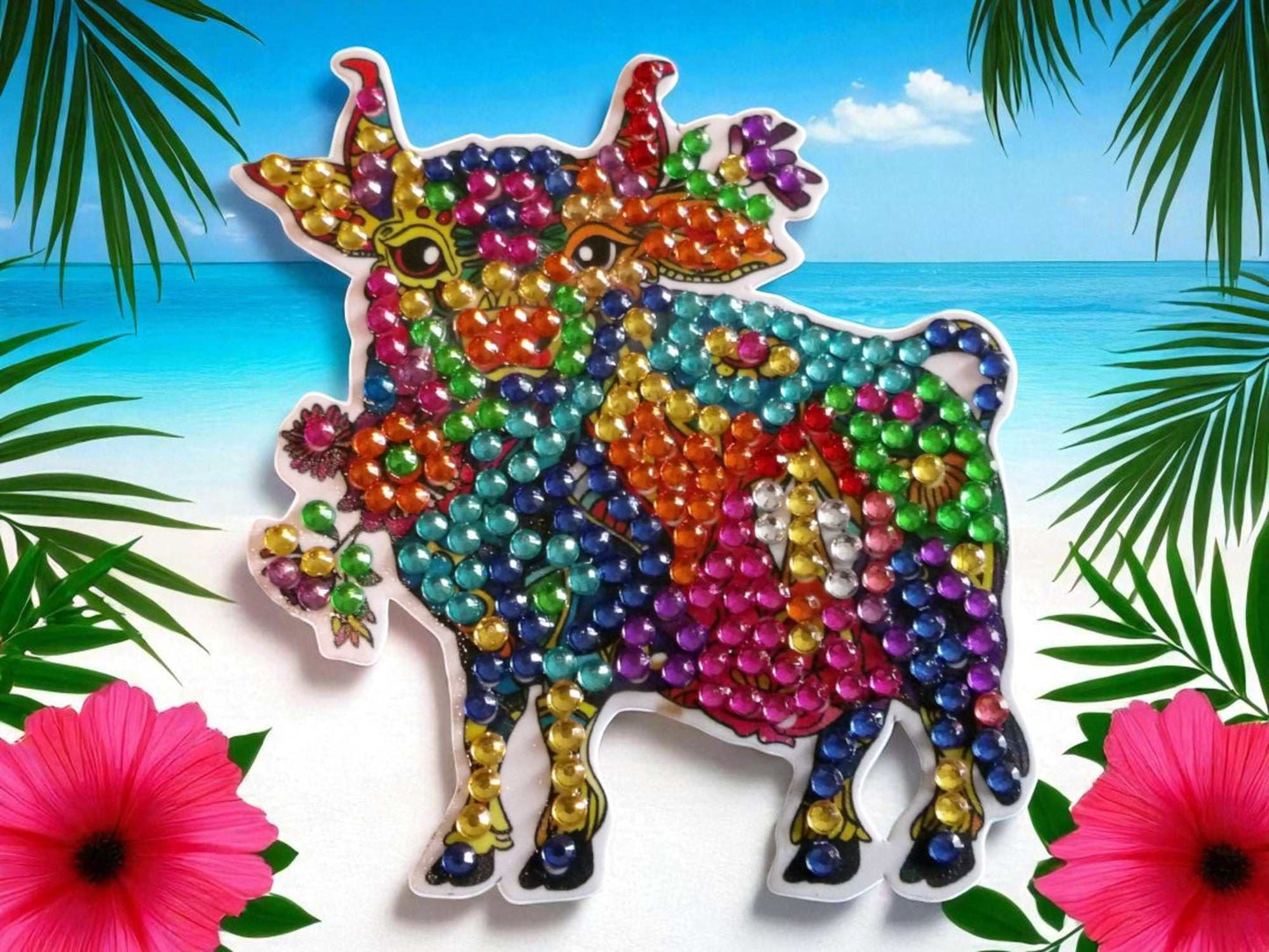 Vibrant colorful bull magnet with multicolored beads on tropical background