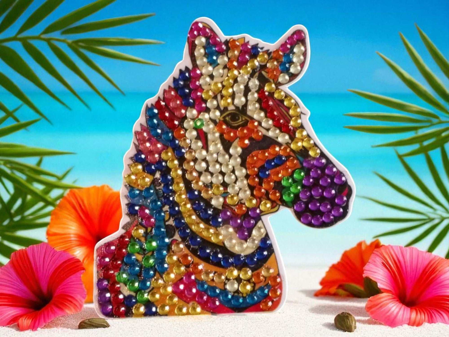 Colorful zebra head magnet decorated with multicolored beads on a tropical background