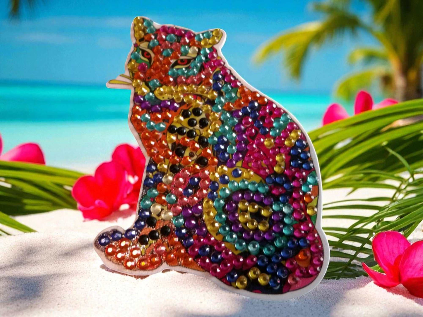 Colorful Cougar Magnet decorated with vibrant beads in a tropical beach setting