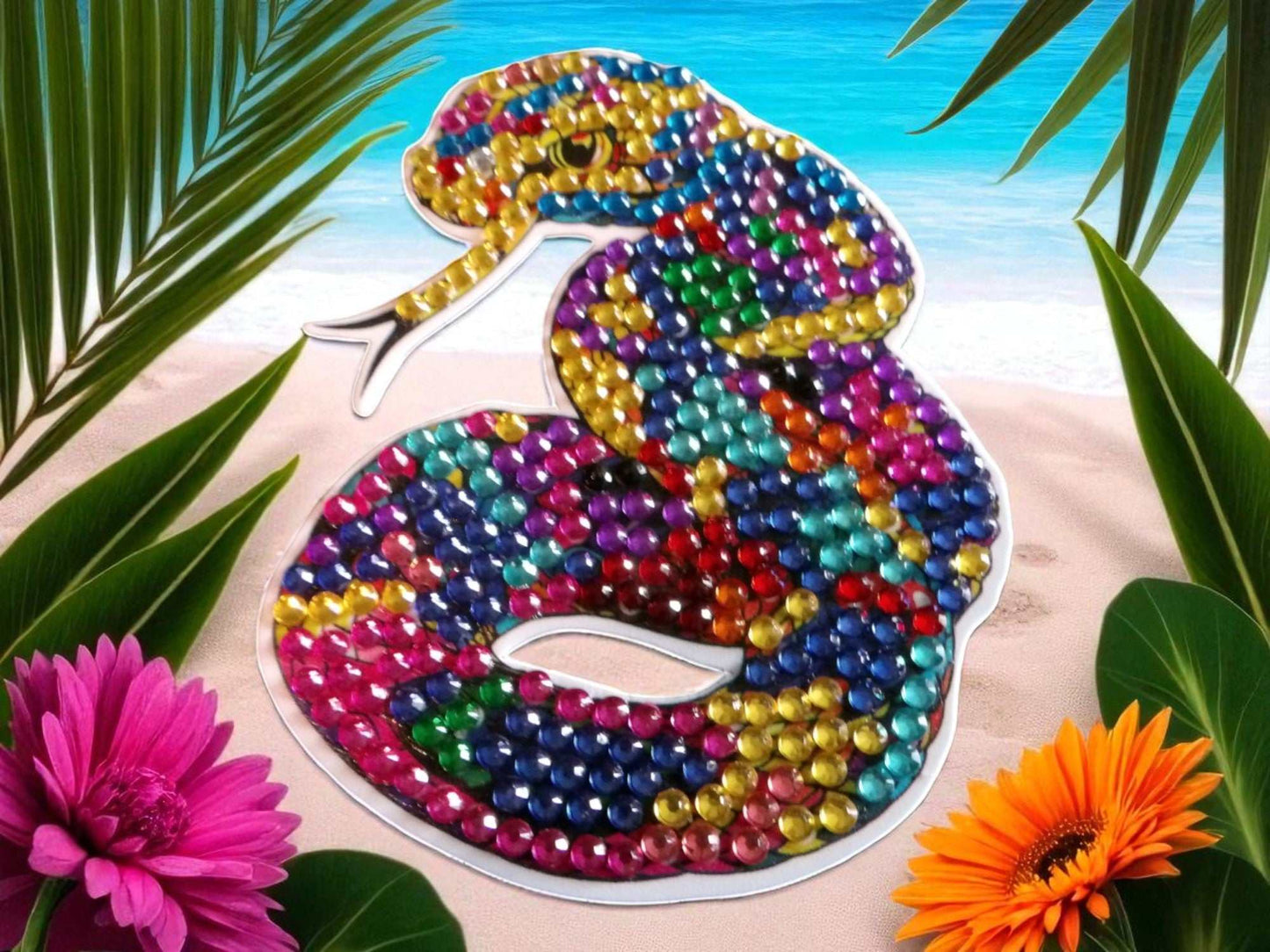 Colorful snake-shaped magnet with vibrant jewel tones on tropical beach background