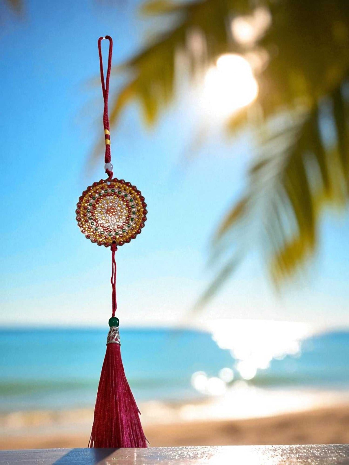 Deep red colorful design car ornament hanging with beach background