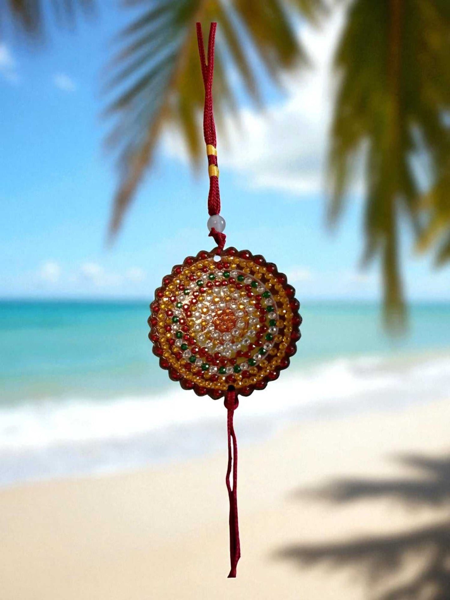 Deep red colorful design hanging car ornament with intricate beaded pattern