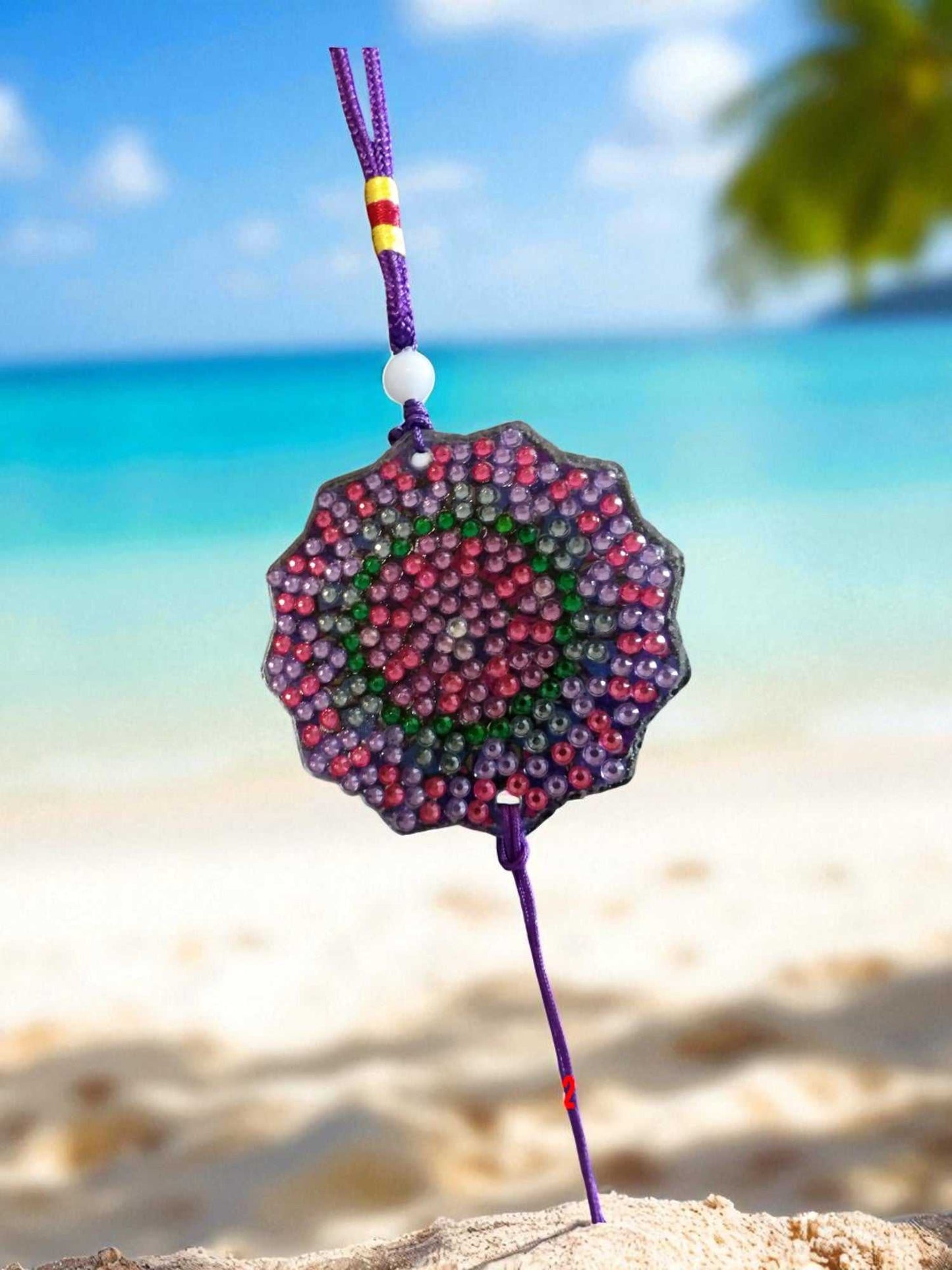 Deep blue colorful design car ornament hanging with vibrant beads by the beach background