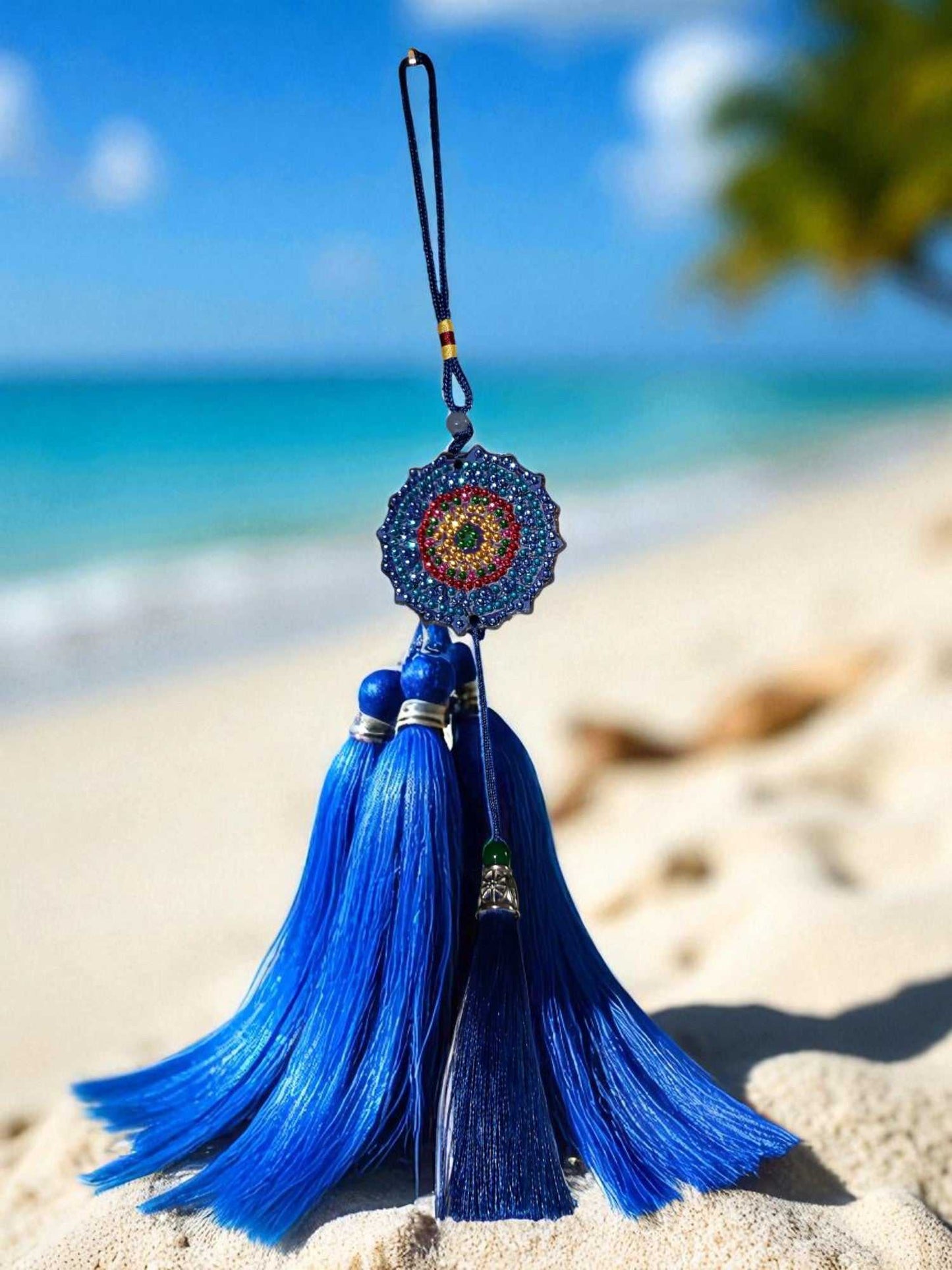 Dark blue colorful design car ornament with tassels hanging outdoors