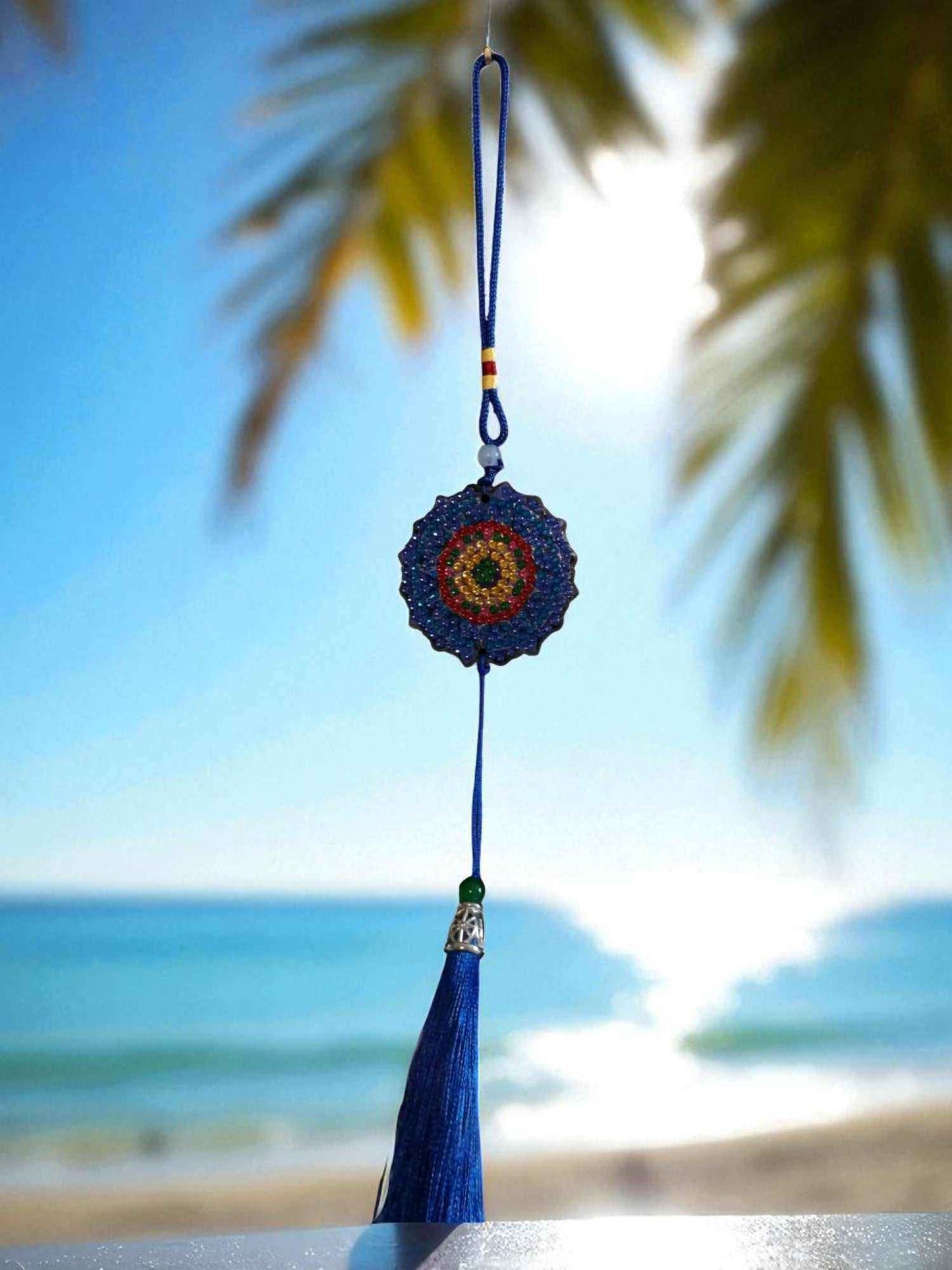 Dark blue colorful design car ornament hanging with beach background