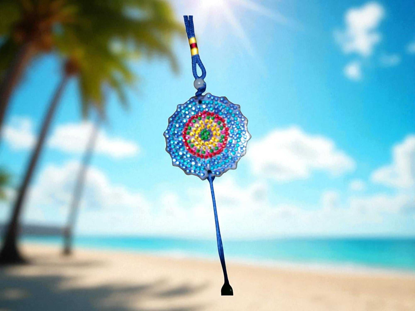 Dark blue colorful design car ornament hanging with a beach background