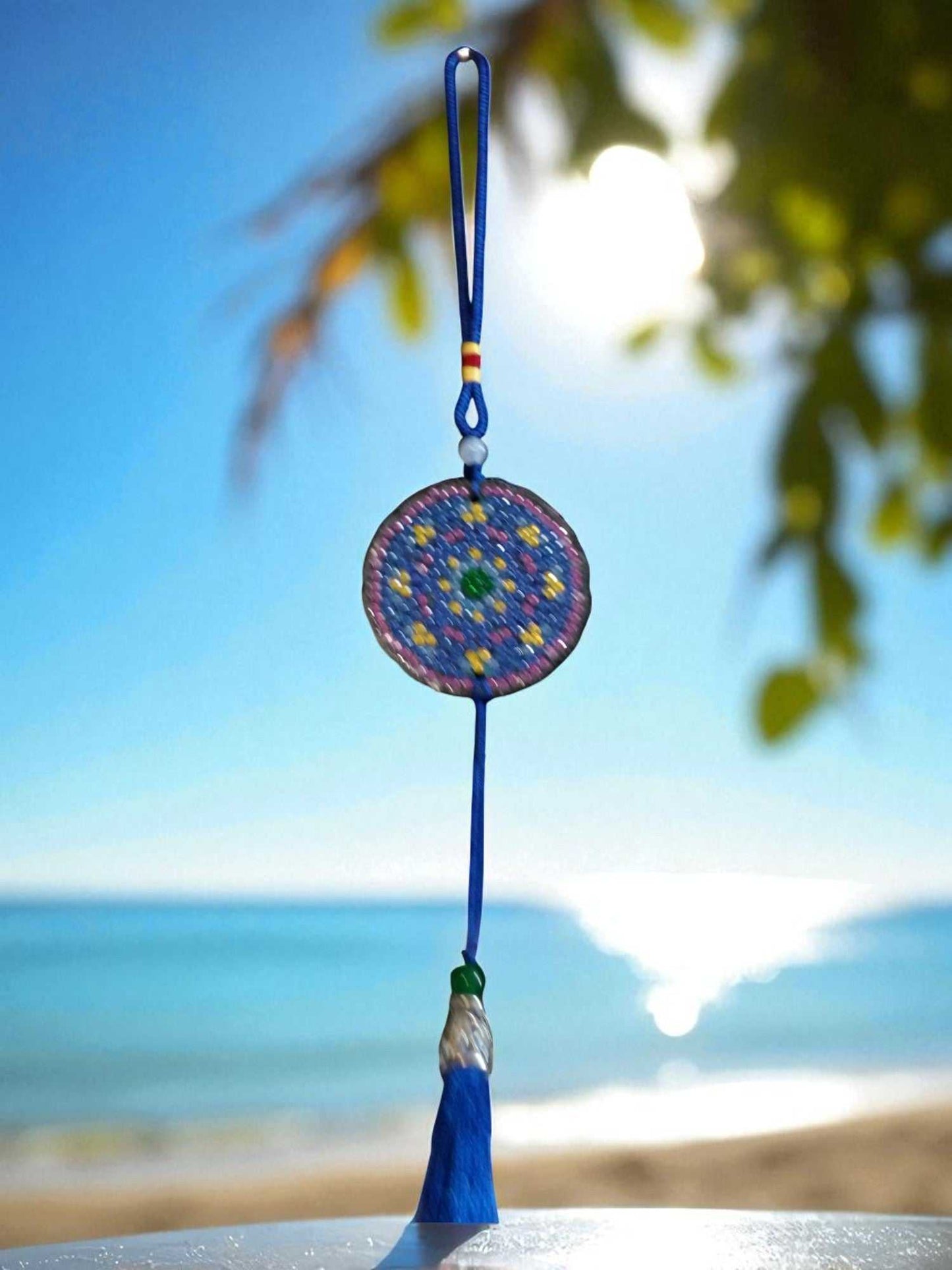 Blue & yellow colorful design car ornament hanging with beach background