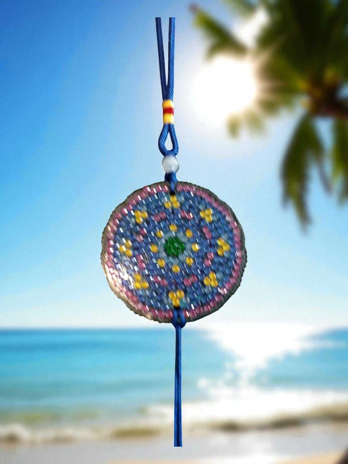 Blue and yellow colorful design car ornament hanging with beach background