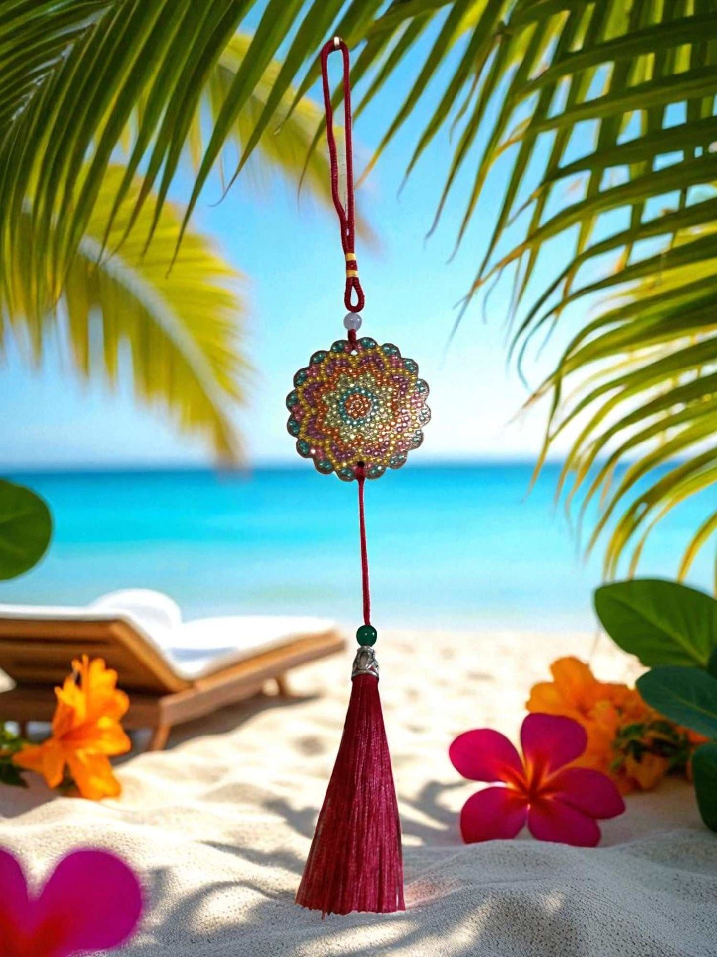 Pink Blue Yellow colorful design car ornament with tassel hanging in bright tropical beach setting