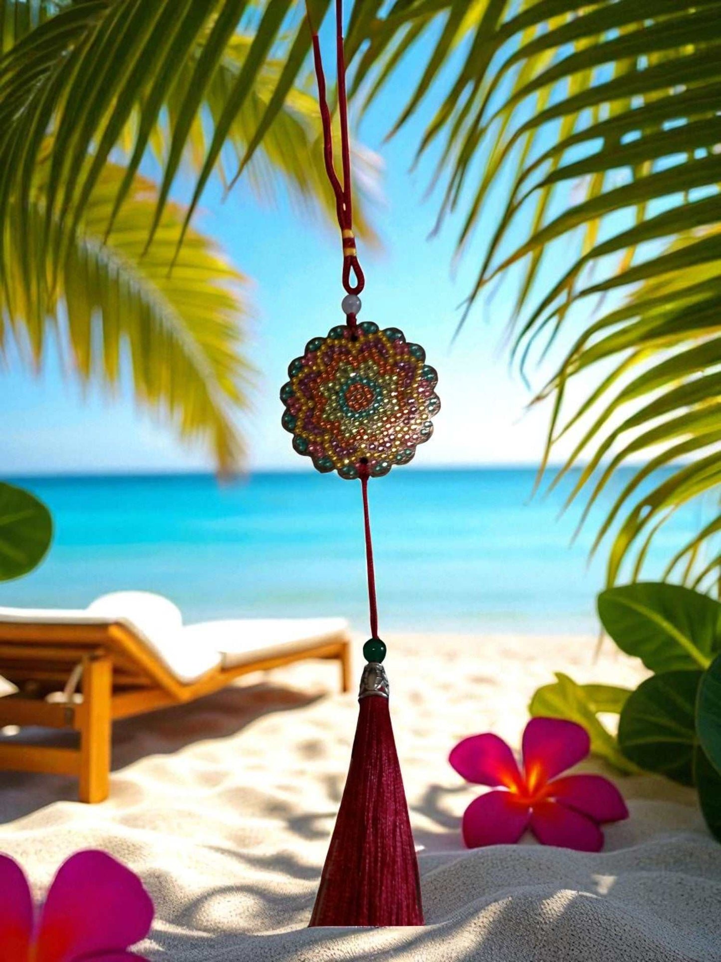 Pink Blue Yellow Colorful Design hanging car ornament with tassel on beach background