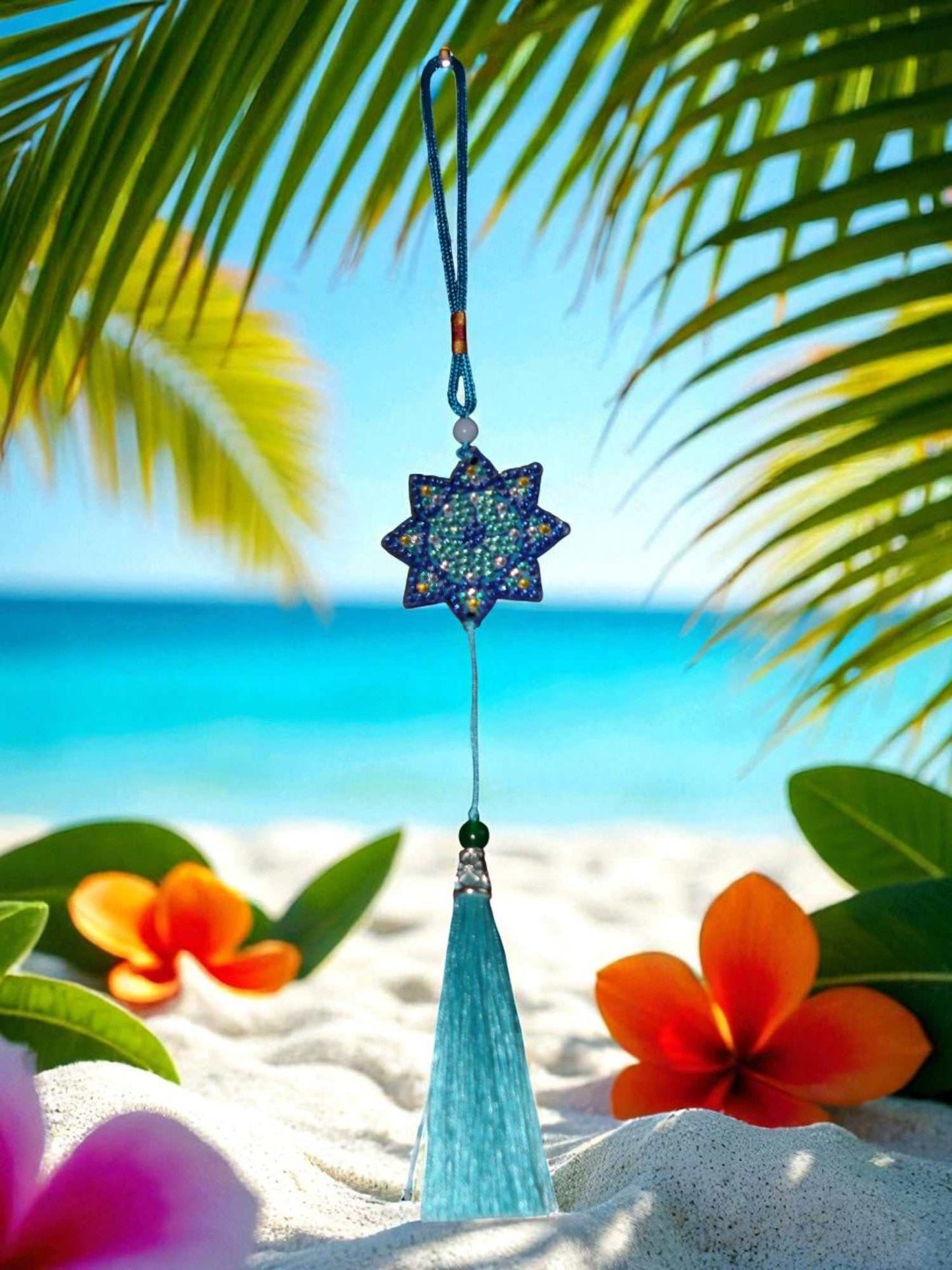Light Blue Star colorful hanging car ornaments with tassel against tropical beach background