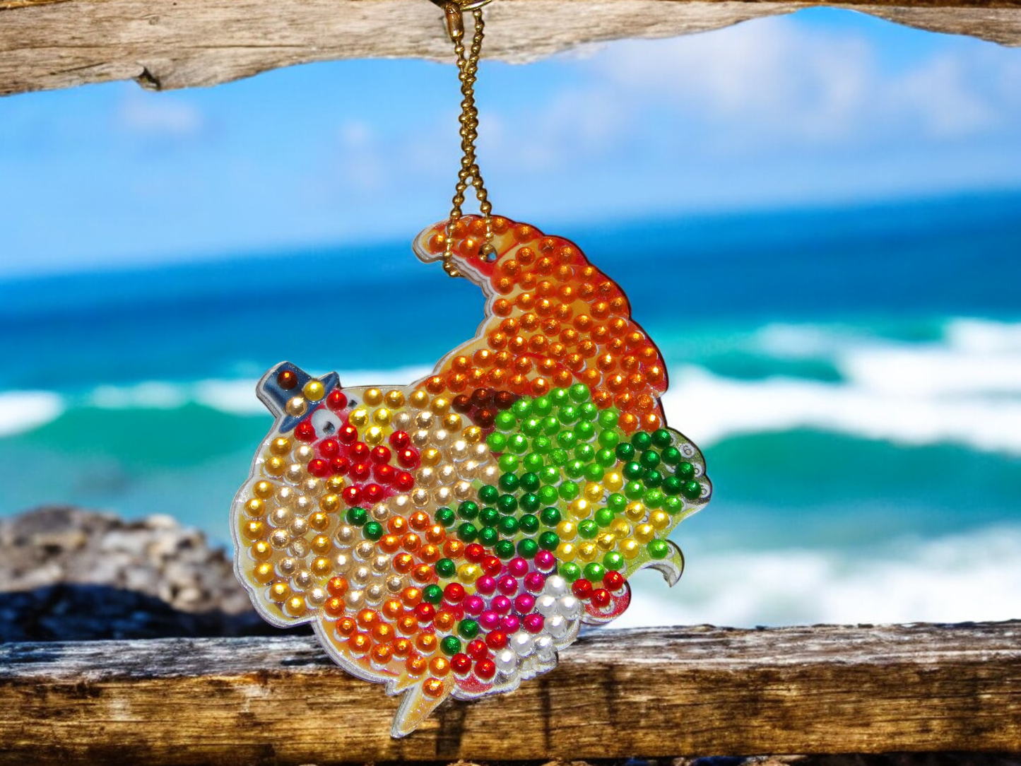Colorful Gord Keychain with vibrant beads hanging outdoors near the ocean