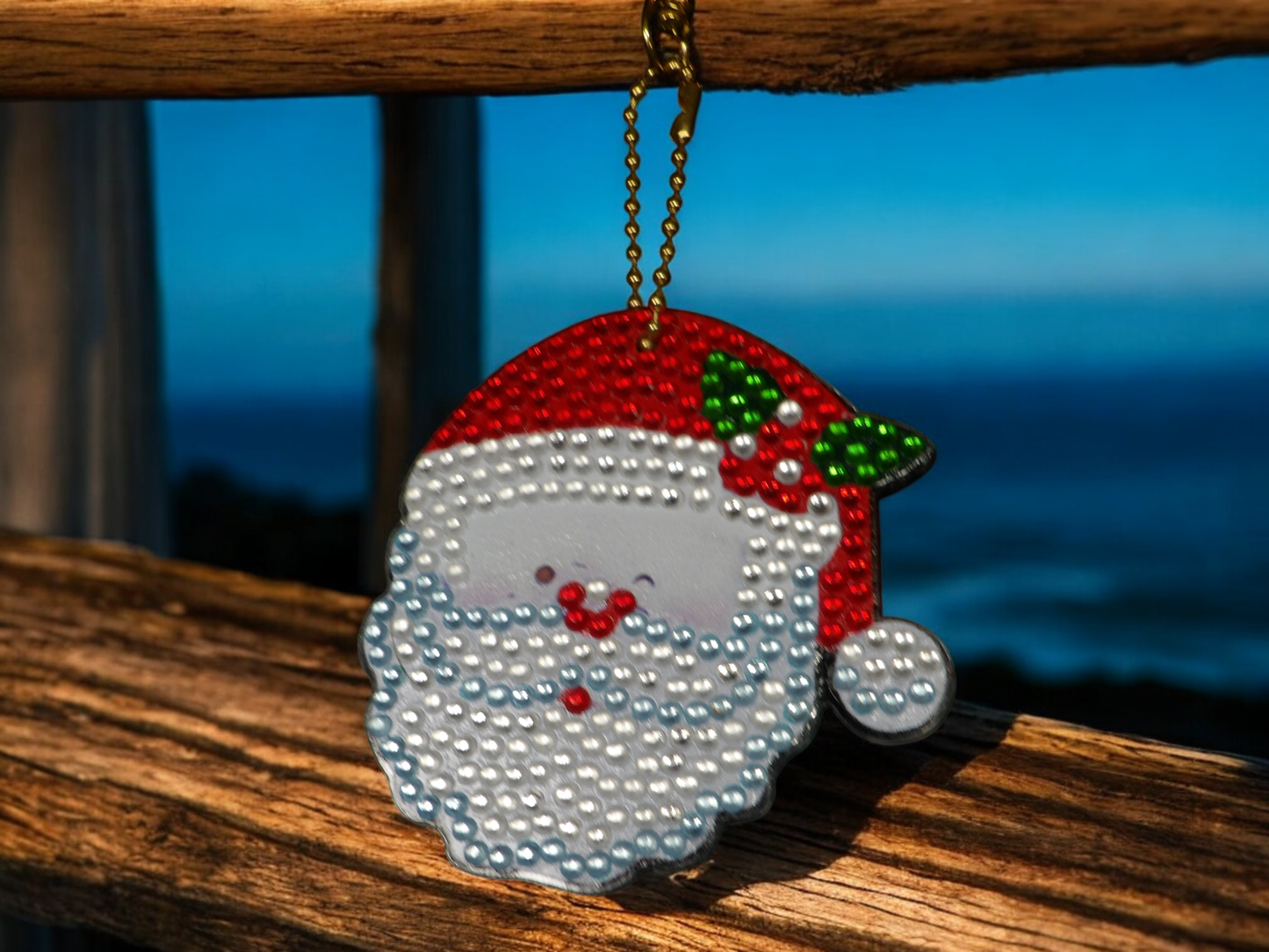 Santa Clause Face Keychain with red hat and white beard hanging on a wooden surface