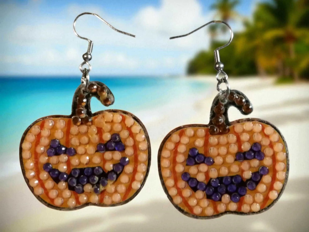 Glow in the dark pumpkin earrings with beaded jack-o'-lantern design