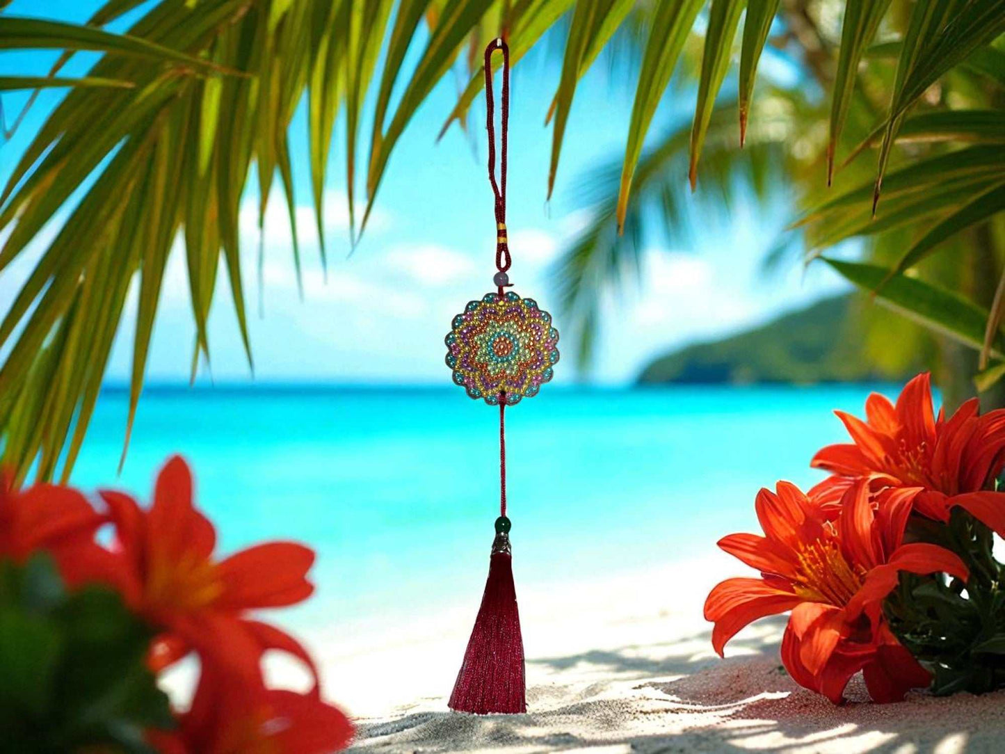 Colorful pink blue yellow car ornament hanging with tassel against tropical beach background